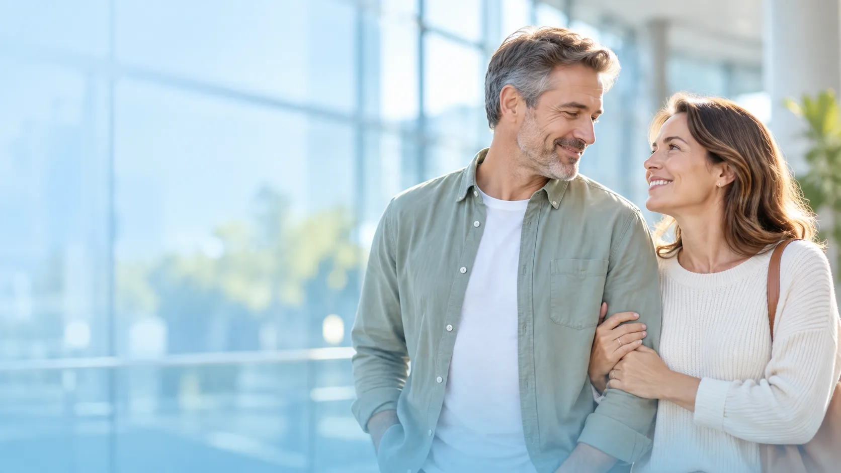 A couple together in a sunlit atrium